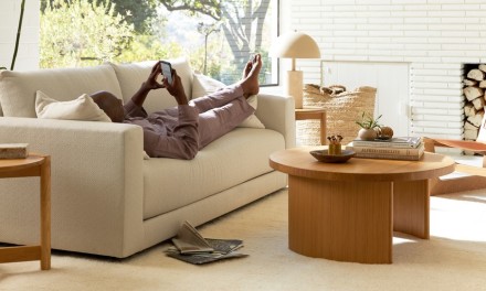 Man relaxing on sofa in bright neutral room