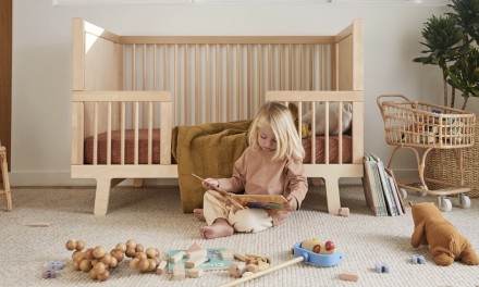 child in front of a crib 