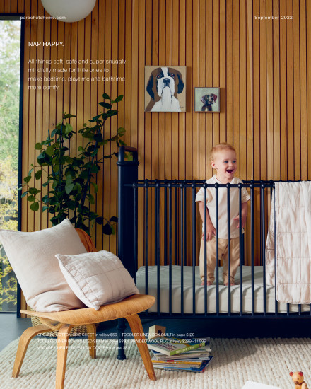 A baby laughing in a crib