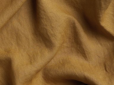 Close Up Of Ochre Washed Linen Curtain