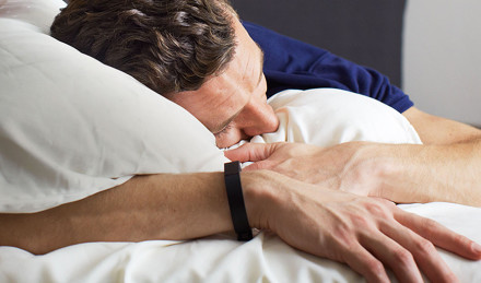 man sleeping wearing a sleep tracker