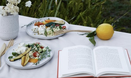 two plates of food and a book on the table 