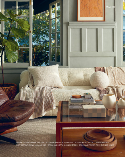 A living room with a collection of Parachute blankets and pillows in white tones.