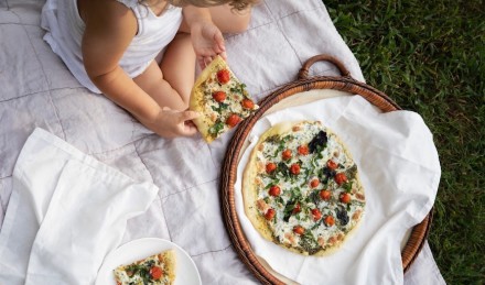 Toddler eating pizza