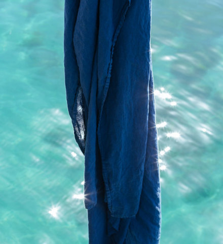 Indigo fabric floating above ocean water.