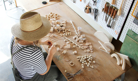 Woman putting the wood on strings