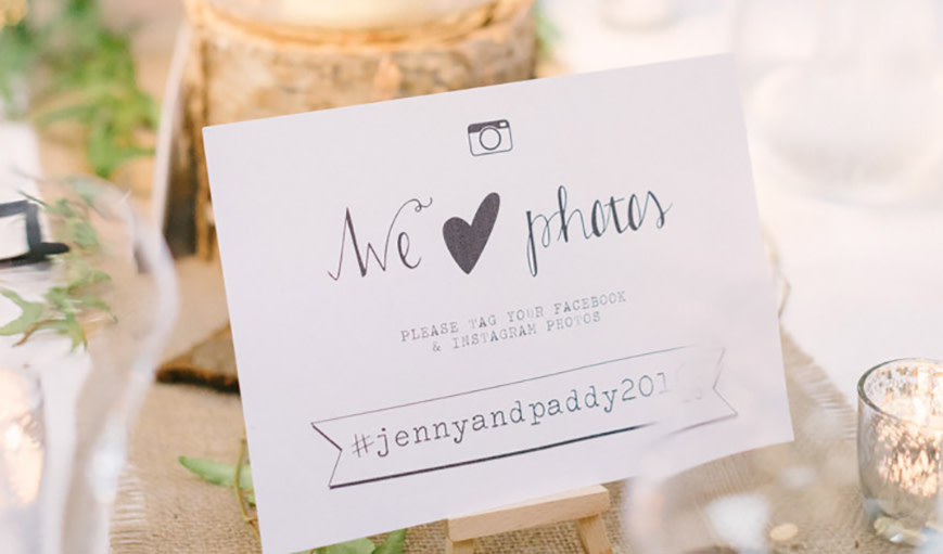 A card with a wedding hashtag 