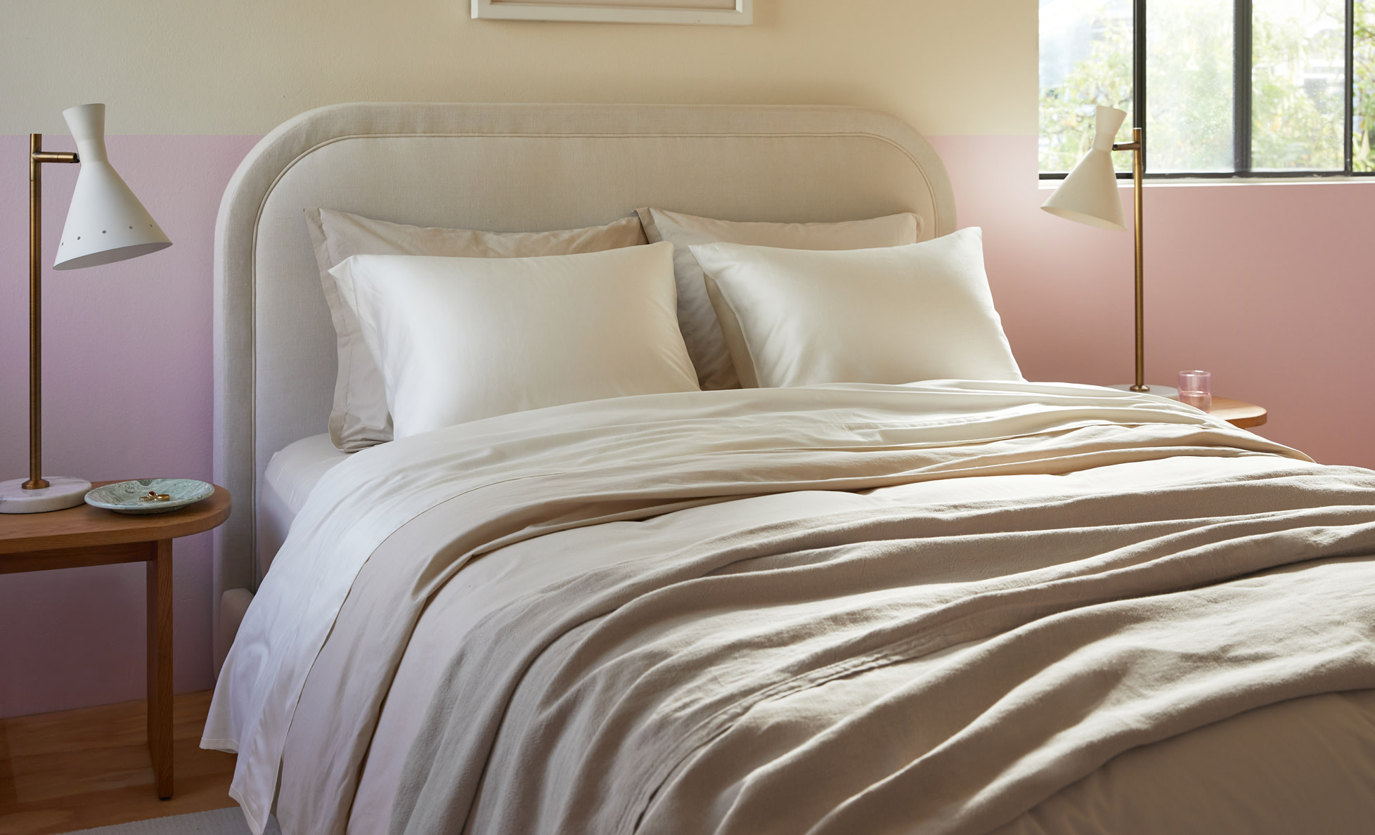 Neatly made bed featuring Cream Sateen sheeting