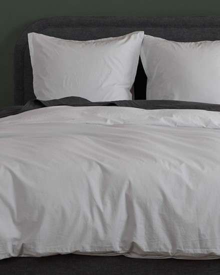 A bed with light grey and dark grey slate percale sheets