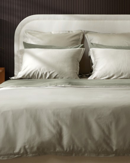 A bed with light green willow sateen sheets