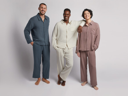 Three men wearing gauze sleepwear in blue, ivory, and purple