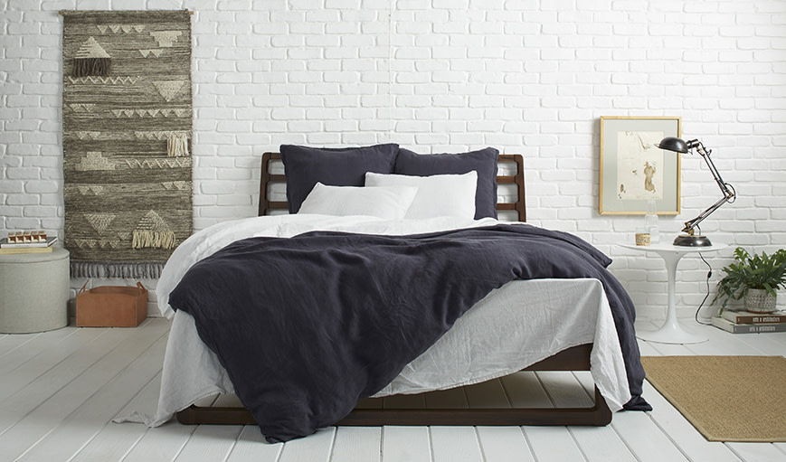Coal linen bedding on a bed 