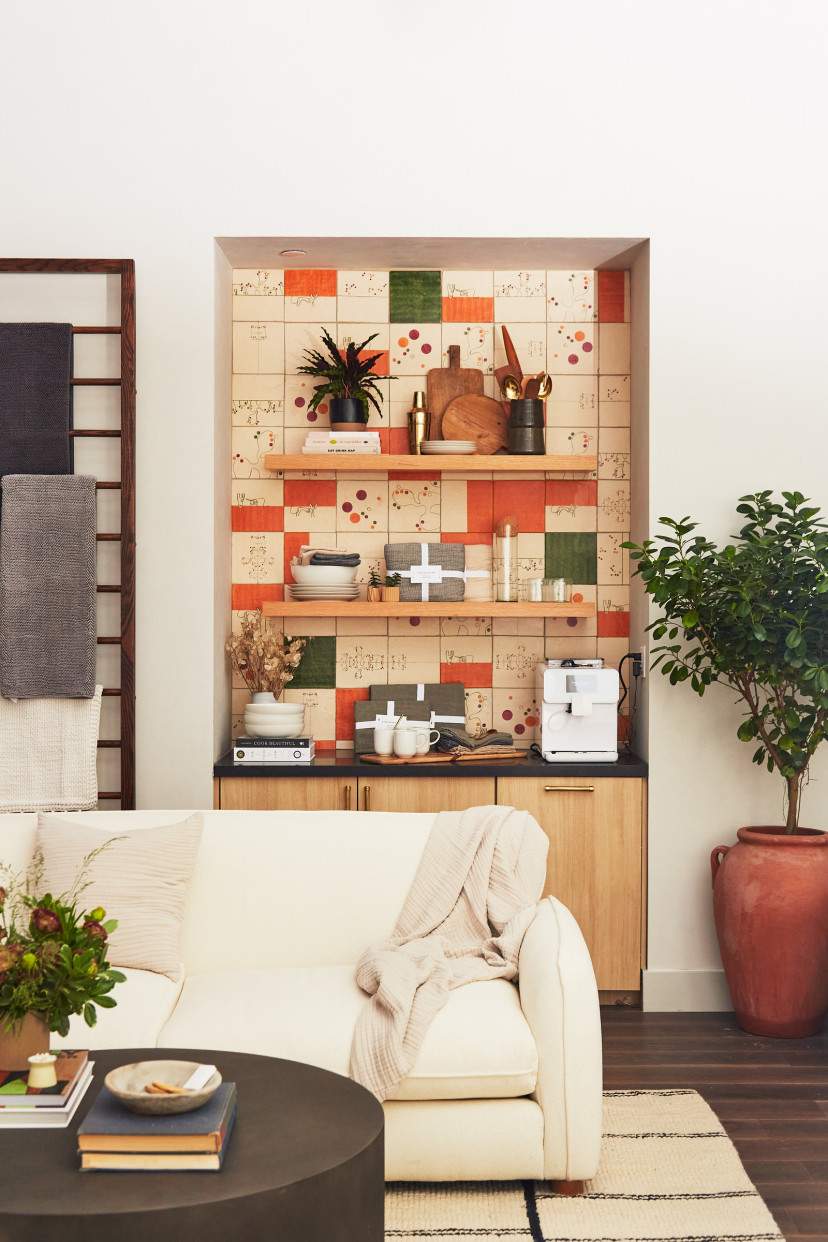 Shelves with colorful orange and tan tiles, stacked with neatly folded Parachute products