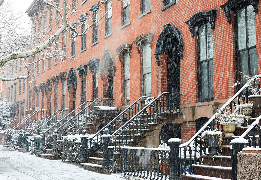 Snow in front of Brooklyn homes. 