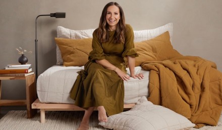 Ariel Kaye sitting on day bed. 