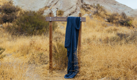 Indigo fabric draped over California sign. 