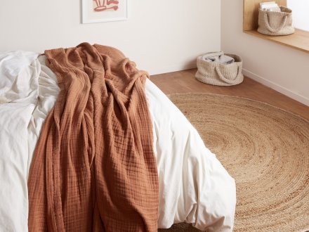 Round Jute Rug Shown In A Room