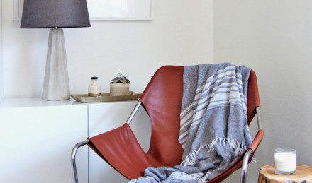 image of a chair draped with a blanket 