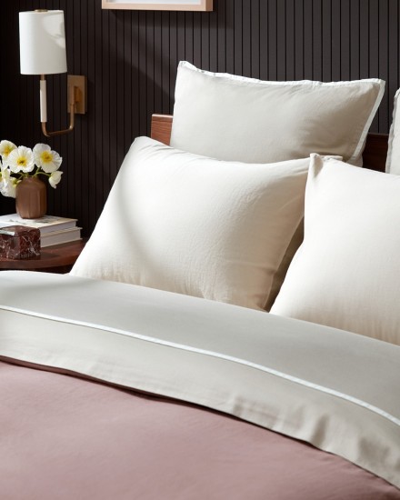 A tidy bed with bone organic soft luxe and clover brushed cotton sheets
