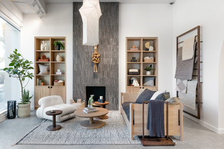 Living room with home items stacked on wall shelving with two couches facing each other