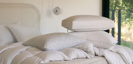 Pillows and duvet inserts laying on a mattress without cases