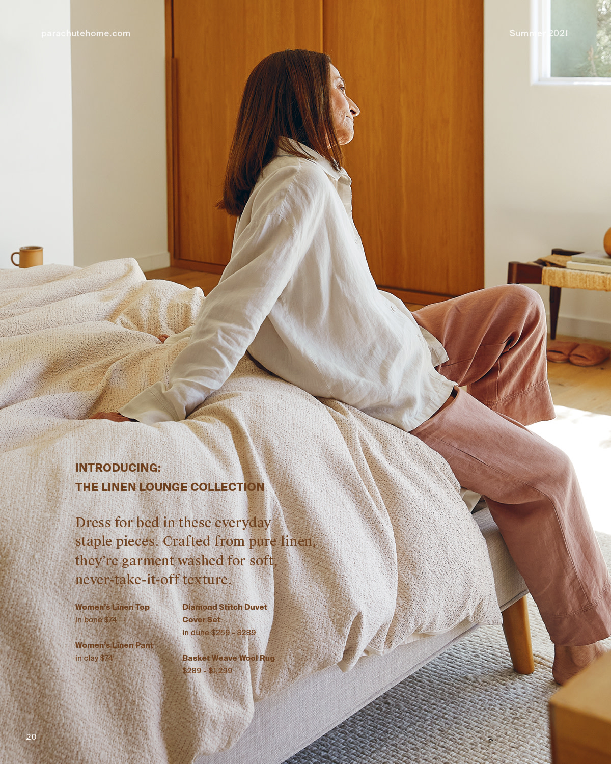 Woman in linen loungewear sitting at the base of her bed