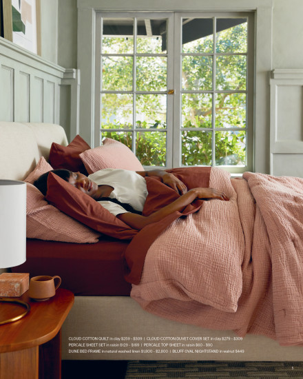 A side view of a bed in a mixture of warm color tones.