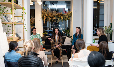 Women sitting listening to another woman speaking