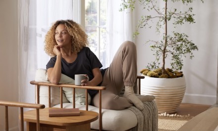 woman sitting in a chair next to an end table 