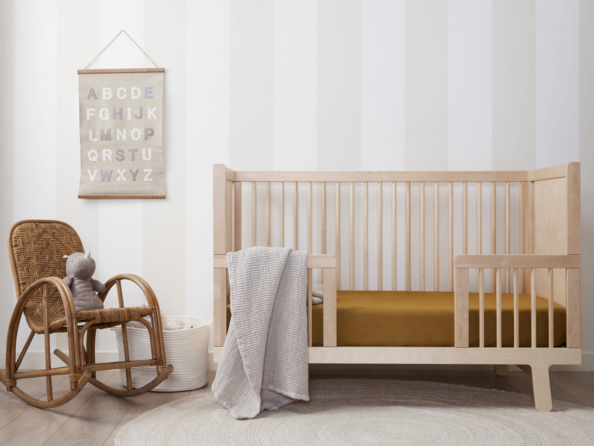 Ochre Brushed Cotton Crib Sheet Shown In A Room