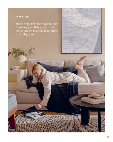 Woman laying on her couch wearing the bone linen loungewear