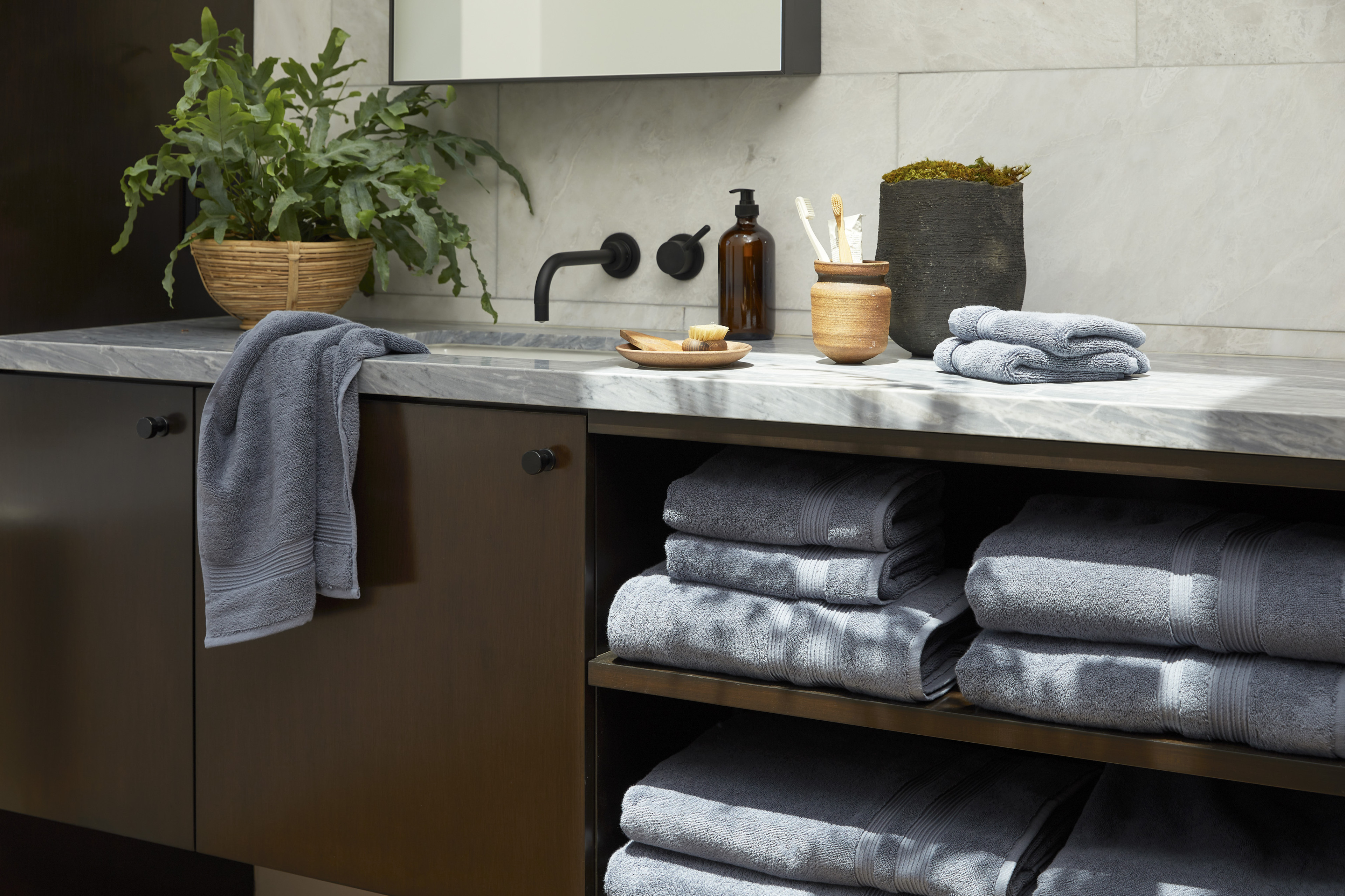 A bathroom with an assortment of towels and decor items.