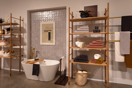 Bathtub and wooden shelving with assorted Parachute towels