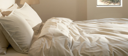 A bed with crisp white cotton sheets