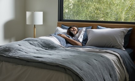 a man sleeping in a layered bed