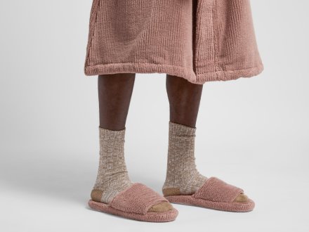 Soft Rib Slippers Shown In A Room
