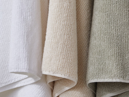 White, flax, and willow towels hanging side by side