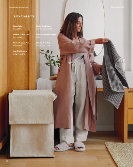 Woman standing in her linen loungewear holding her waffle towels