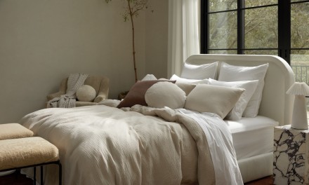 a bed with many pillows
