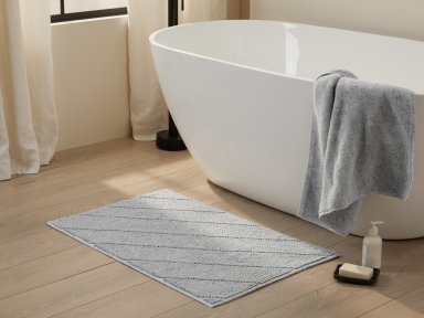 Grey Speckled Bath Rug Shown In A Room