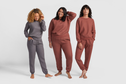 Three women standing side by side wearing waffle lounge sets.