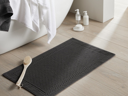 Textured Border Bath Rug Shown In A Room