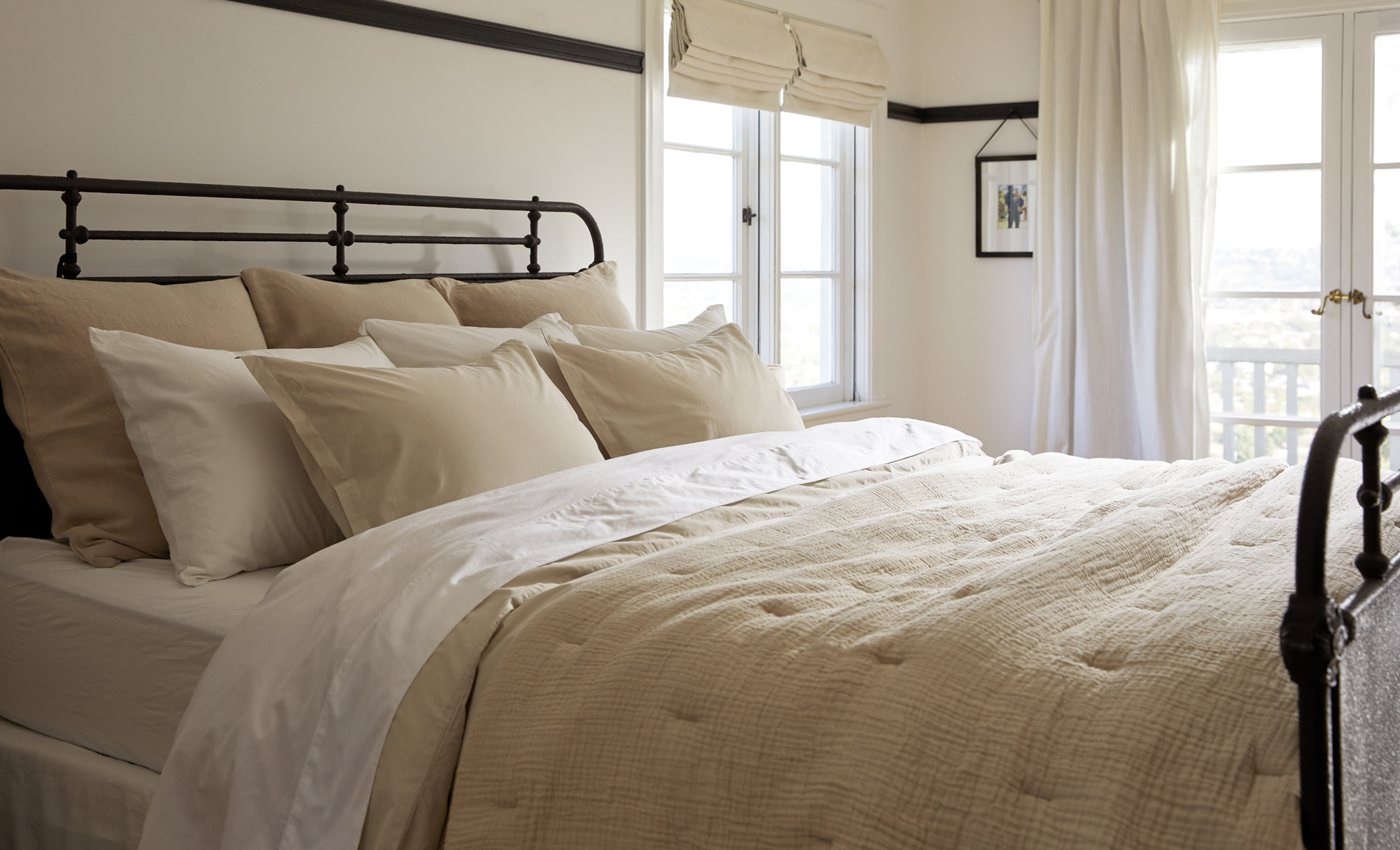 Neatly made bed featuring Ivory and Bone Brushed Cotton sheeting