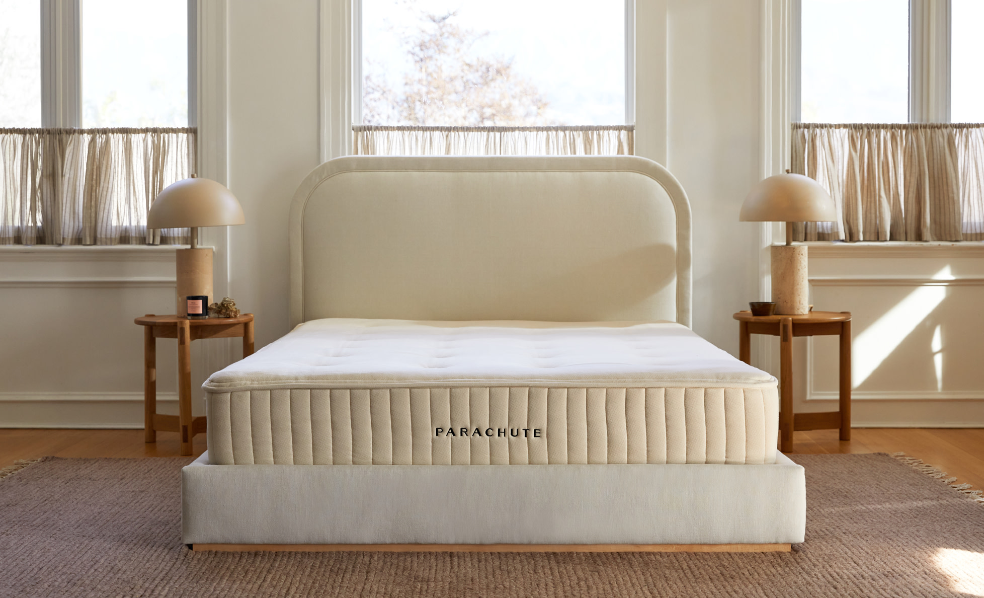 Mattress resting on a bed frame in a bright bedroom