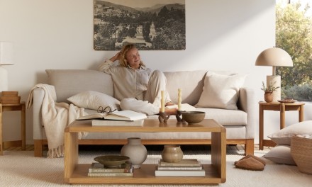 woman sitting on a couch behind a coffee table