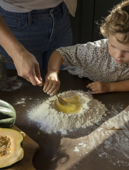 Toddler making pasta. 