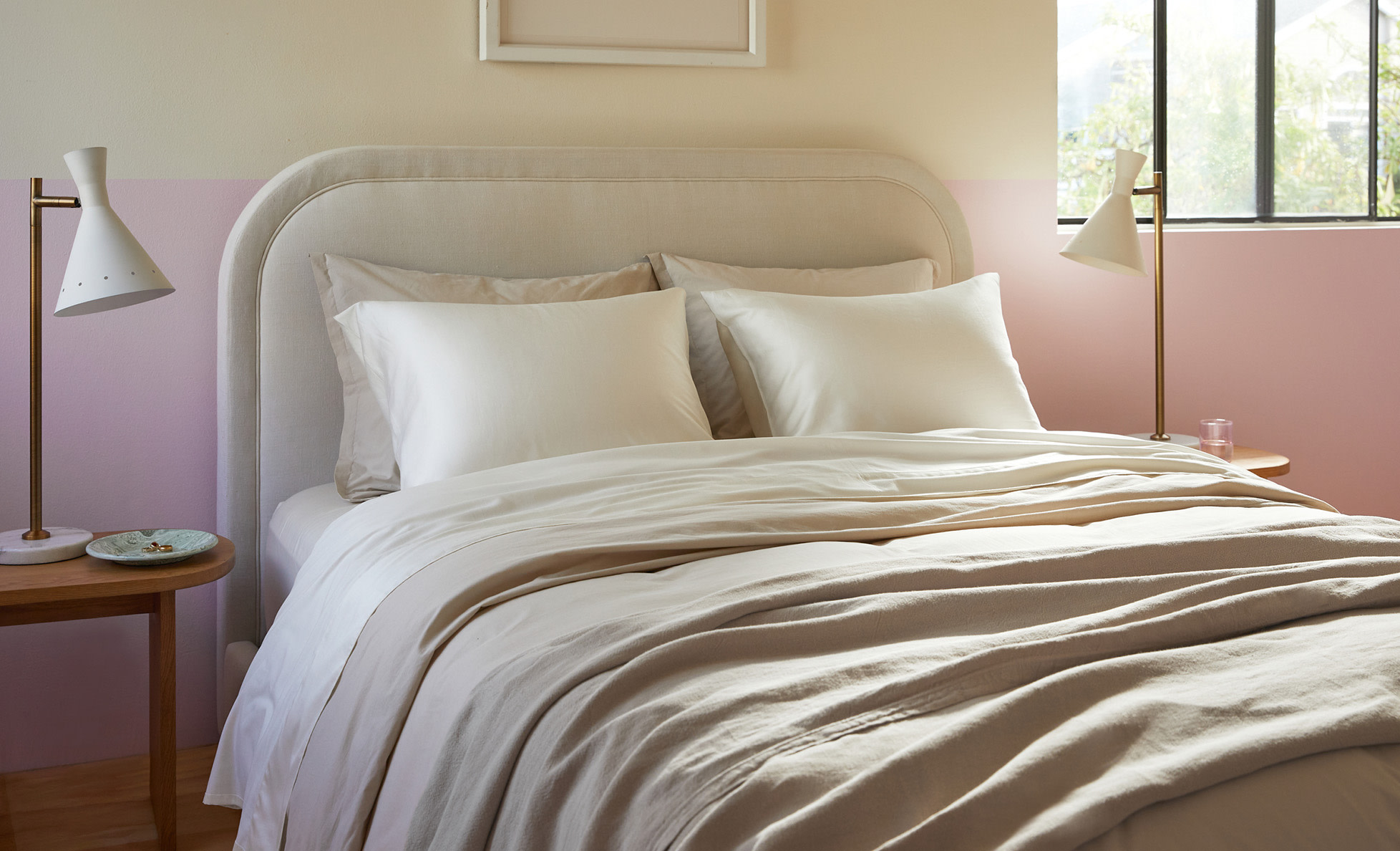 A tidy bed with neutral sateen sheets