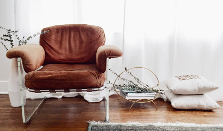 Large leather chair with books next to it. 