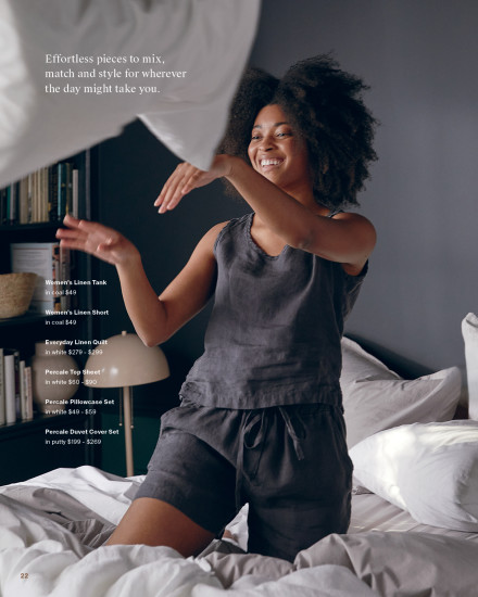 Woman throwing a pillow playfully wearing the coal linen tank and shorts