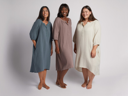 Three women wearing a gauze sleep dress in blue, purple, and ivory